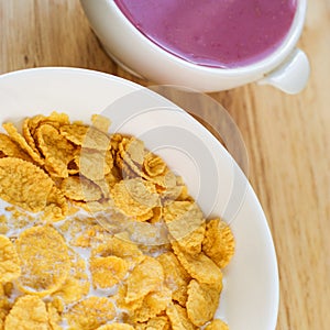 A country breakfast with blueberry yogurt, milk and cornflakes