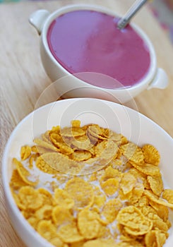 A country breakfast with blueberry yogurt, milk and cornflakes