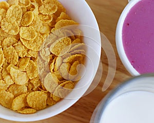 A country breakfast with blueberry yogurt, milk and cornflakes