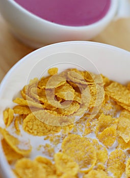 A country breakfast with blueberry yogurt, milk and cornflakes