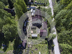 Country cottage area in forest, aerial view at Russian village at summer season