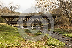 Country covered bridge over running brook