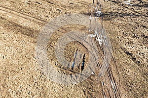 Country dirt road in winter time. landscape with traces of cars on the ground. aerial view