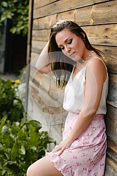 Country girl on a background of a wooden wall