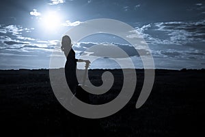 Country girl with guitar at field