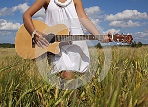 Country girl sitting with guitar photo