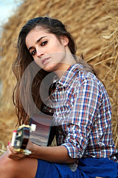 Country girl strumming a guitar