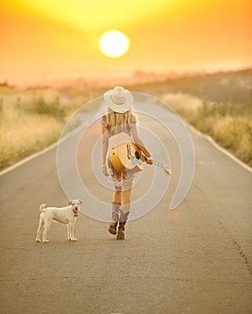 Country girl walking down a sunset road