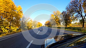 Country highway with a marking sunny autumn day