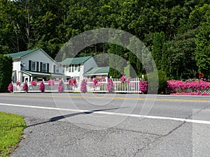 Country Home With White Picket Fence and Flowers