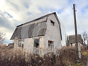 Country house overgrown with grass in autumn