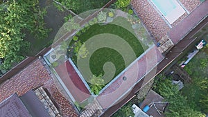Country house with a swimming pool top view. Flying over a beautiful house with a swimming pool and green lawn