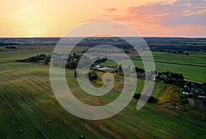 Country houses in the countryside. Aerial view of roofs of green field with rural homes. Village with wooden home. Suburban house