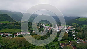 Country houses mountain valley landscape aerial view. Gloomy green hills village