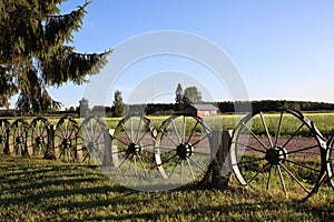 A country landscape with a retro fence and a red barn