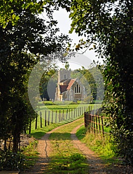 Country lane and petty church of St Deny`s Church, Little Barford, Bedfordshire photo