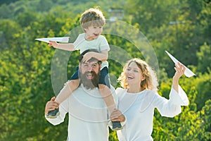 Country life. Adopt kid. Dad mom and his child son are playing on sky background. Spring time. Happy father giving