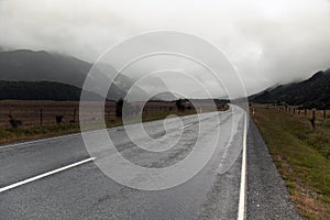 Country mountain road in rain and clouds