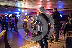 Country music band playing and people dancing in the Broken Spoke dance hall in Austin, Texas