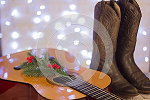 Country music christmas with acoustic guitar and cowboy shoes