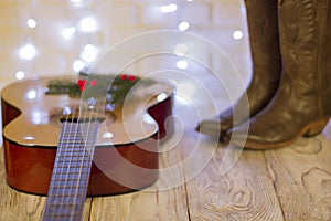 Country music christmas with guitar and cowboy shoes