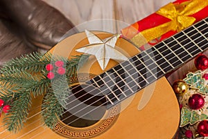 Country music christmas background with guitar and cowboy boots