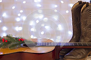 Country music christmas background with guitar and cowboy shoes