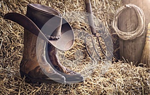 Country music festival live concert or rodeo with cowboy hat and boots in barn