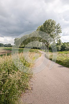 Country path in a rural landscape with threatening clouds