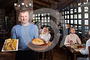 Country restaurant owner with traditional meals