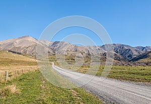 Country road across barren hills in Southern Alps around Molesworth Station, New Zealand