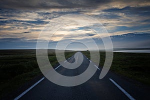 Country road across the tundra landscape in summer night