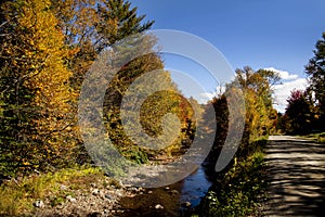 Country Road Along Autumn Stream in Vermont, USA