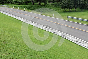 Country road along hillside green grass.