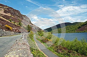 Country road along the lakeside of the Elan valley in the British summertime..