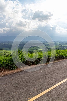 Country road with blue sky and white clouds, Thailand. Travel background