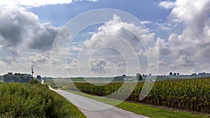 Country road through farm land and rolling hills