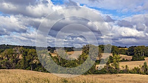 Country road through farm land and rolling hills