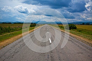 Country road and foothills on a background