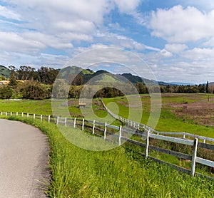 A country road is going up the hill on the left side.