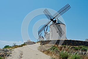 Country road going up to ancient windmills in Consuegra, Castilla La Mancha, Spain