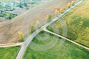 Country road intersection with dirt roads between agricultural fields. autumn landscape. drone photo