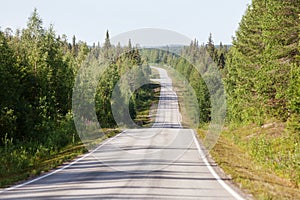 Country road in Lapland, Finland, on a sunny summer day