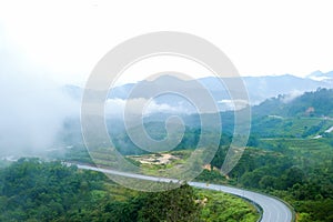 Country road at mountain area with low cloud after rain in Gua Musang, Kelantan, Malaysia