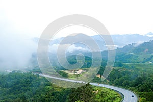 Country road at mountain area with low cloud after rain in Gua Musang, Kelantan, Malaysia