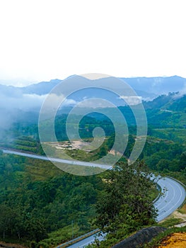 Country road at mountain area with low cloud after rain in Gua Musang, Kelantan, Malaysia