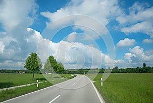 Country road through rural landscape