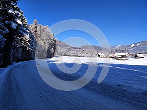 Country road in rural picturesque winter wonderland scenery