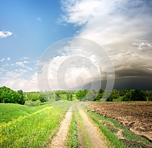 Country road and storm clouds