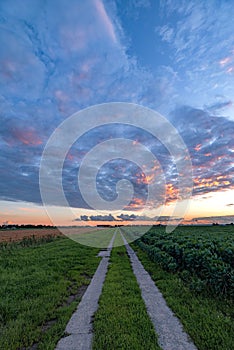 Country road under colorful evening sky